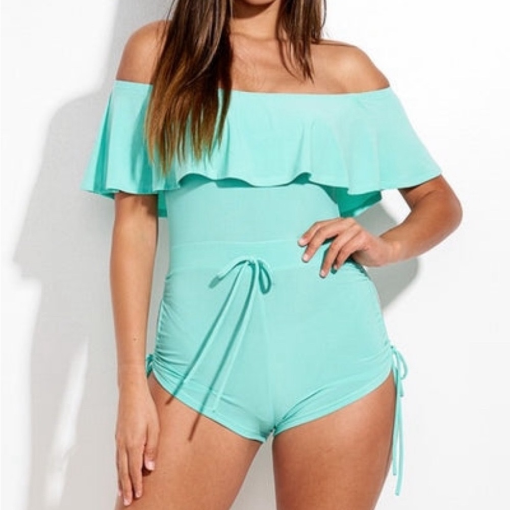 Teal, flirty romper that hangs off shoulders.